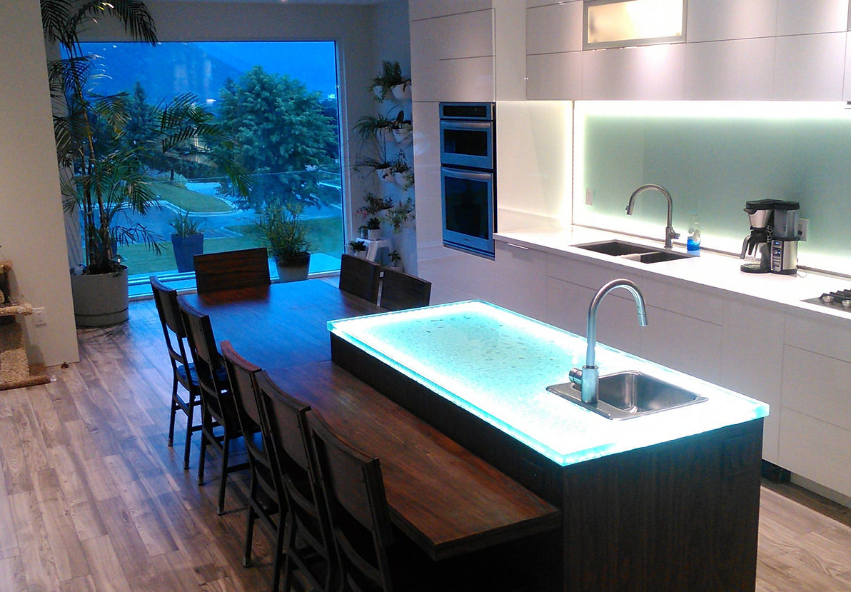 A kitchen with a spacious island and a sink.
